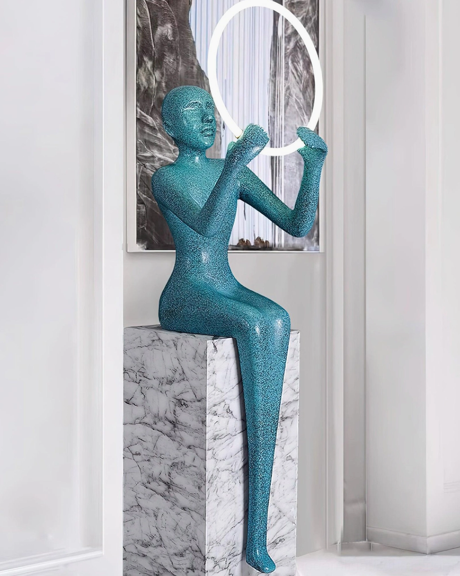 Bella sculptural floor lamp creating ambient warm light with glowing halo effect in interior space