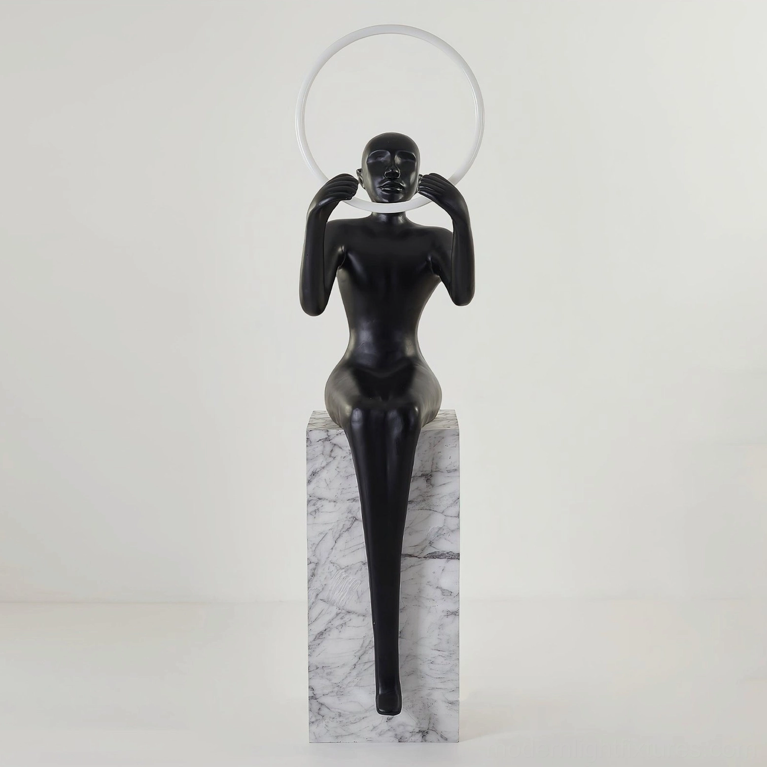 Bella sculptural floor lamp with clear acrylic LED halo ring and marble-textured pedestal, front studio view