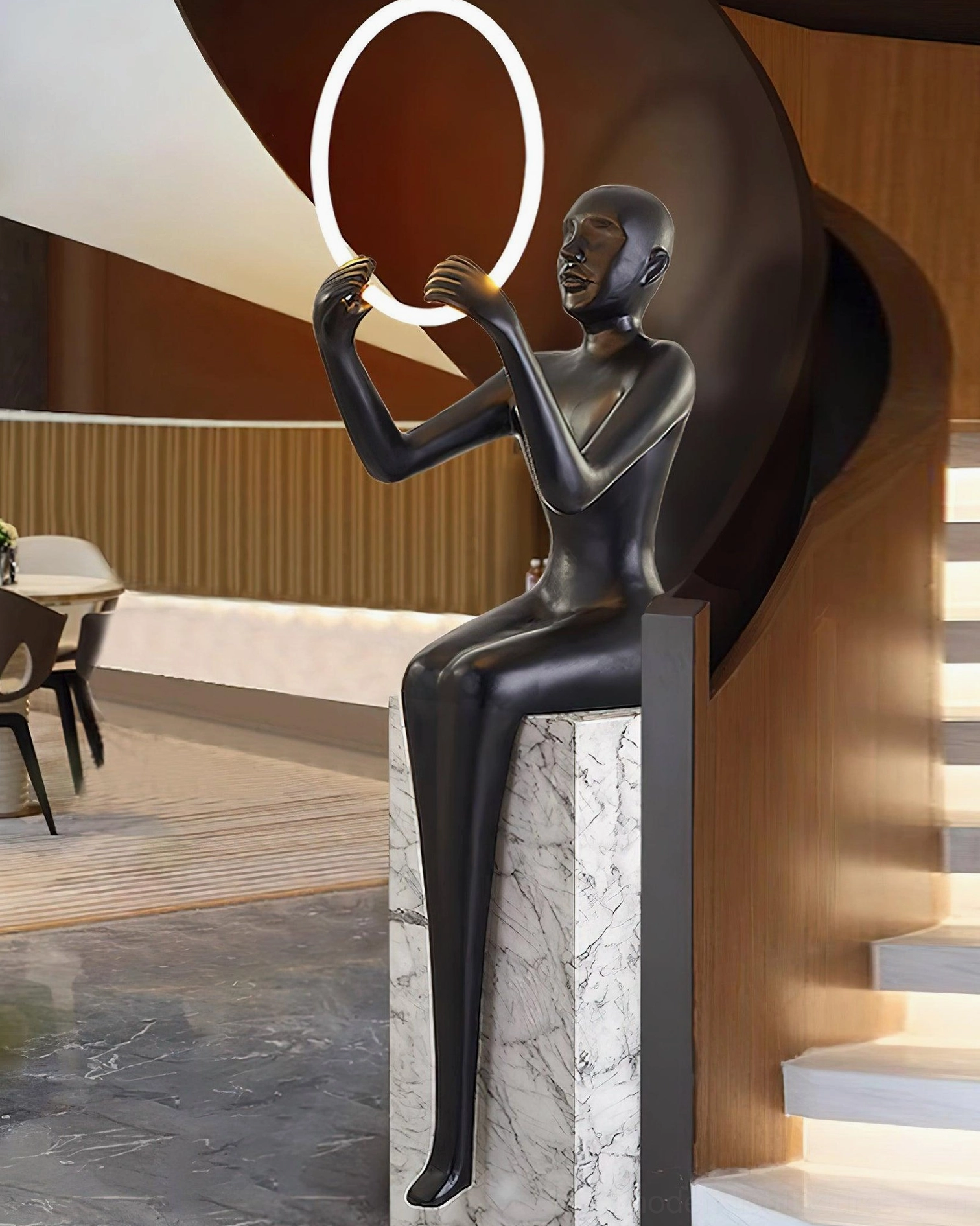 Bella sculptural halo floor lamp showing artistic seated figure with luminous LED crown
