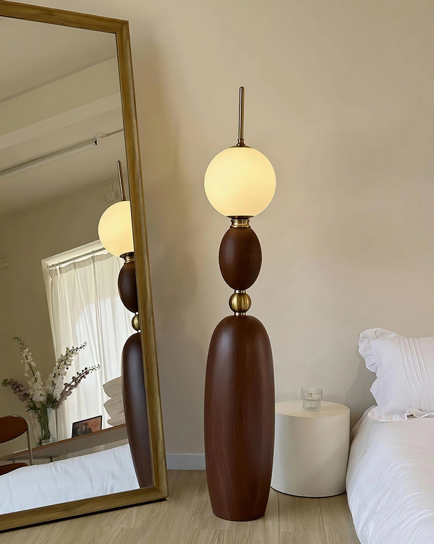 Warm wood grain Bellamy floor lamp in bedroom with vintage modern style and brass hardware