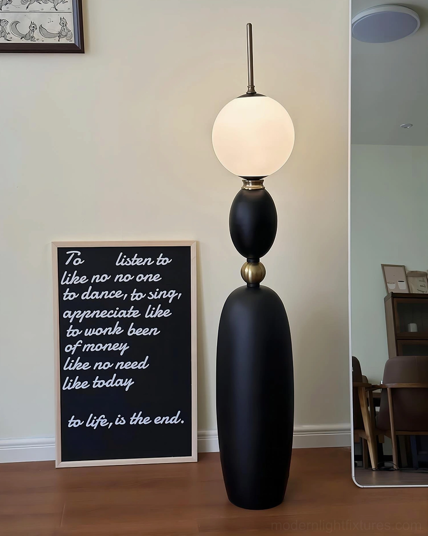 Minimalist luxury Bellamy floor lamp with spherical frosted glass shade in home reading corner