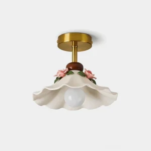 Bellarose ceramic flush mount ceiling light with scalloped shade, hand-applied pink roses, and brushed brass canopy — flat lay studio view