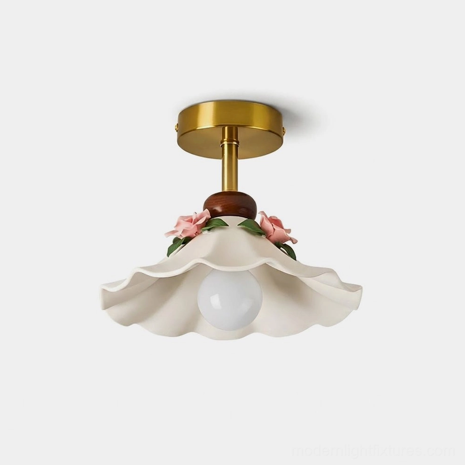 Bellarose ceramic flush mount ceiling light with scalloped shade, hand-applied pink roses, and brushed brass canopy — flat lay studio view