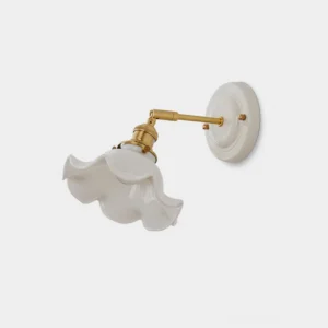 Bellewave rippled ceramic wall sconce with brass arm and white ruffled shade, front product view