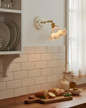 Bellewave wall sconce installed in vintage cottage kitchen nook with subway tile and brass hardware