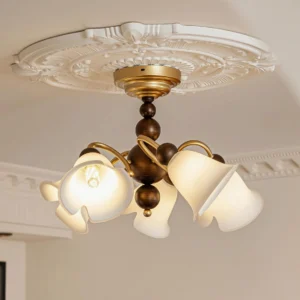 Bellflower ceiling lamp installed overhead in residential bedroom with carved ceiling medallion, warm glowing light illumination