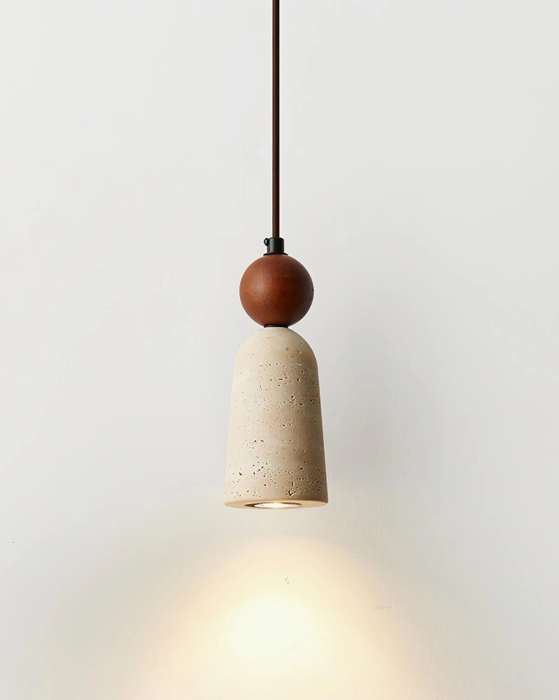 Close-up side view of Bellin pendant fixture with travertine cone shade and wooden accent bead