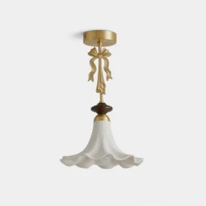 Bellora semi-flush pendant light with pleated white ceramic flower shade, brass bow ornament, and walnut wood accent ring - front studio view
