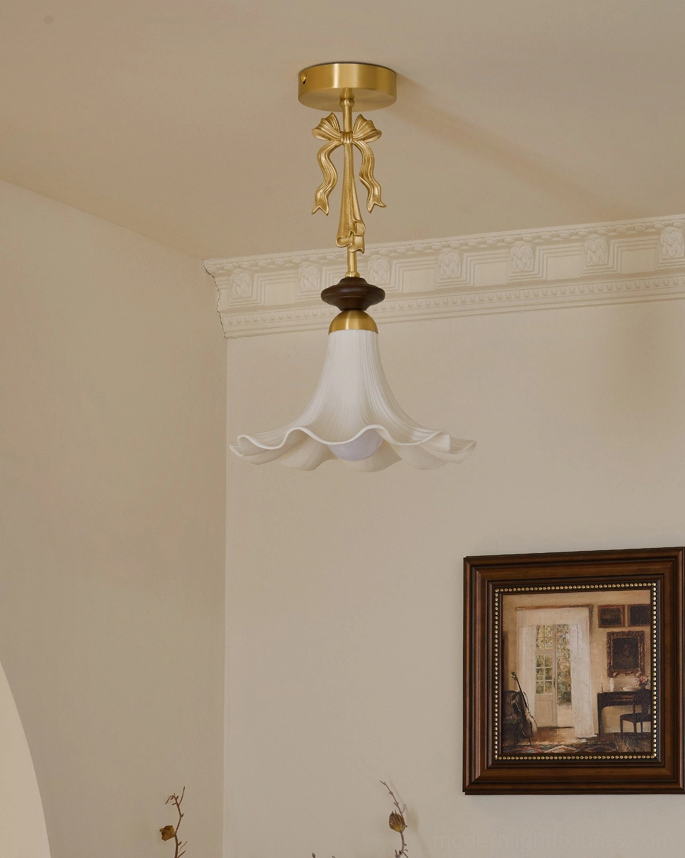 Close-up view of Bellora ceramic pendant shade detail - pleated ceramic texture, scalloped ruffled hem, brass bow ornament accent