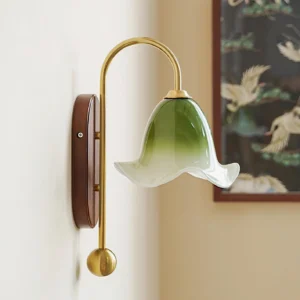 Bellora botanical wall sconce illuminated in corner setting with crane decorative art, showing green gradient glass diffusion