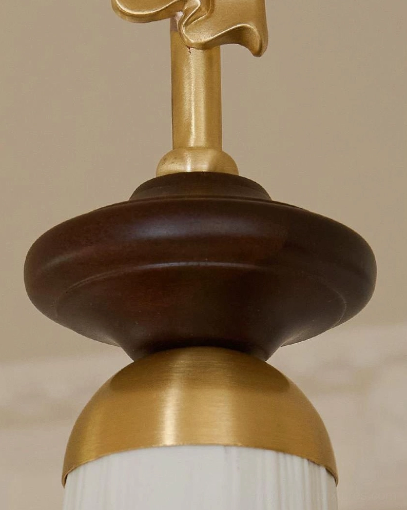 Bellora mini pendant fixture showing full assembly - brass canopy, bow ornament, walnut wood ring, and ceramic shade construction