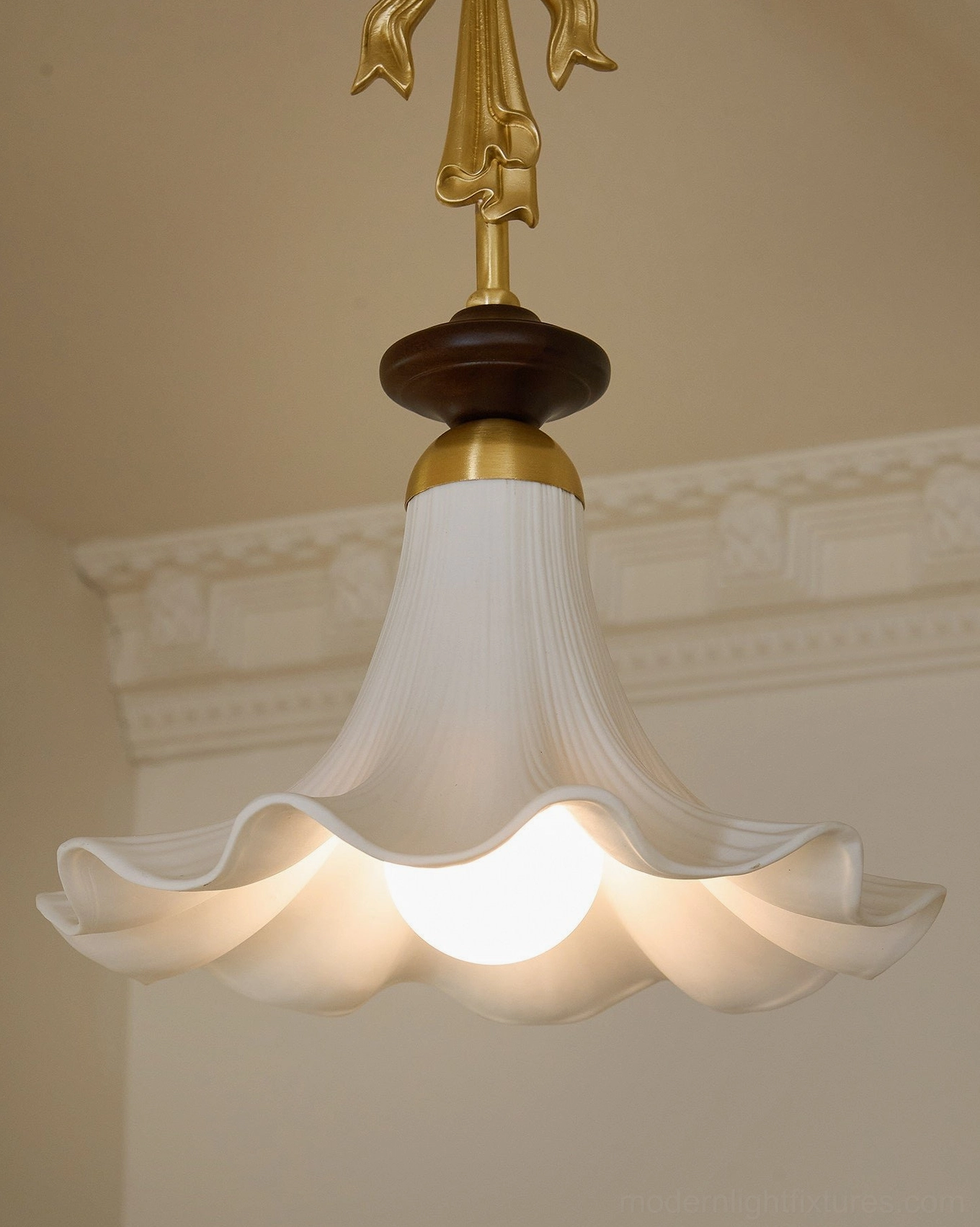 Bellora semi-flush pendant light installed in residential corner showing brass canopy, downrod, and ruffled white ceramic shade