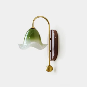 Bellora hand-blown glass wall sconce with gradient green shade, brass arc, and walnut wood backplate mounted on white wall