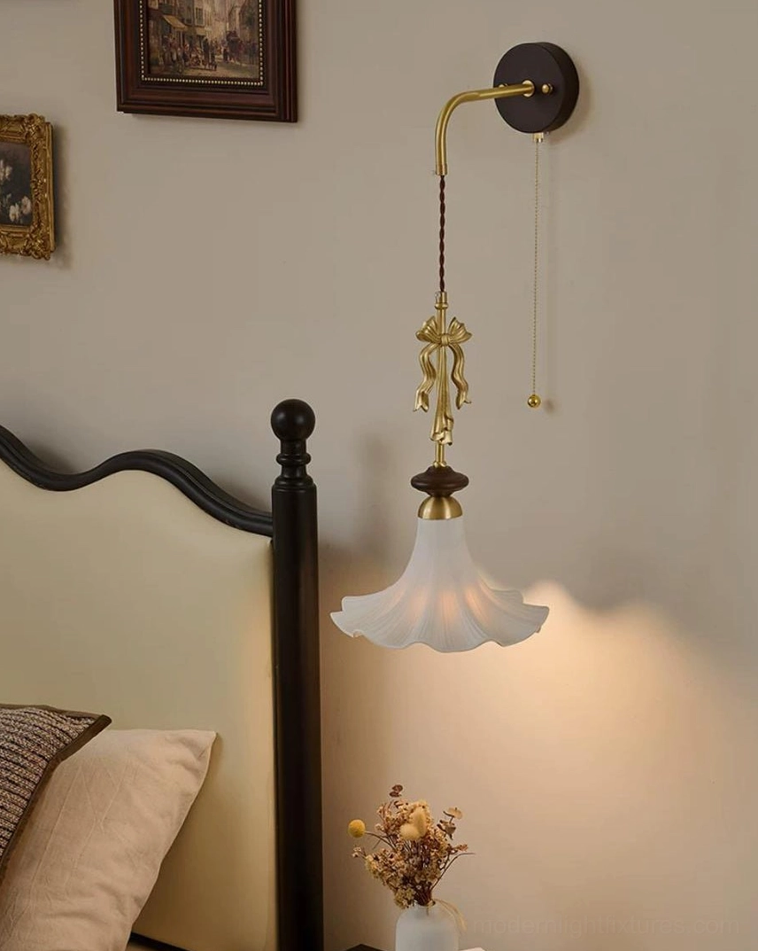Bellora wall sconce installation view - hardwired wall mount with brass bow ornament detail