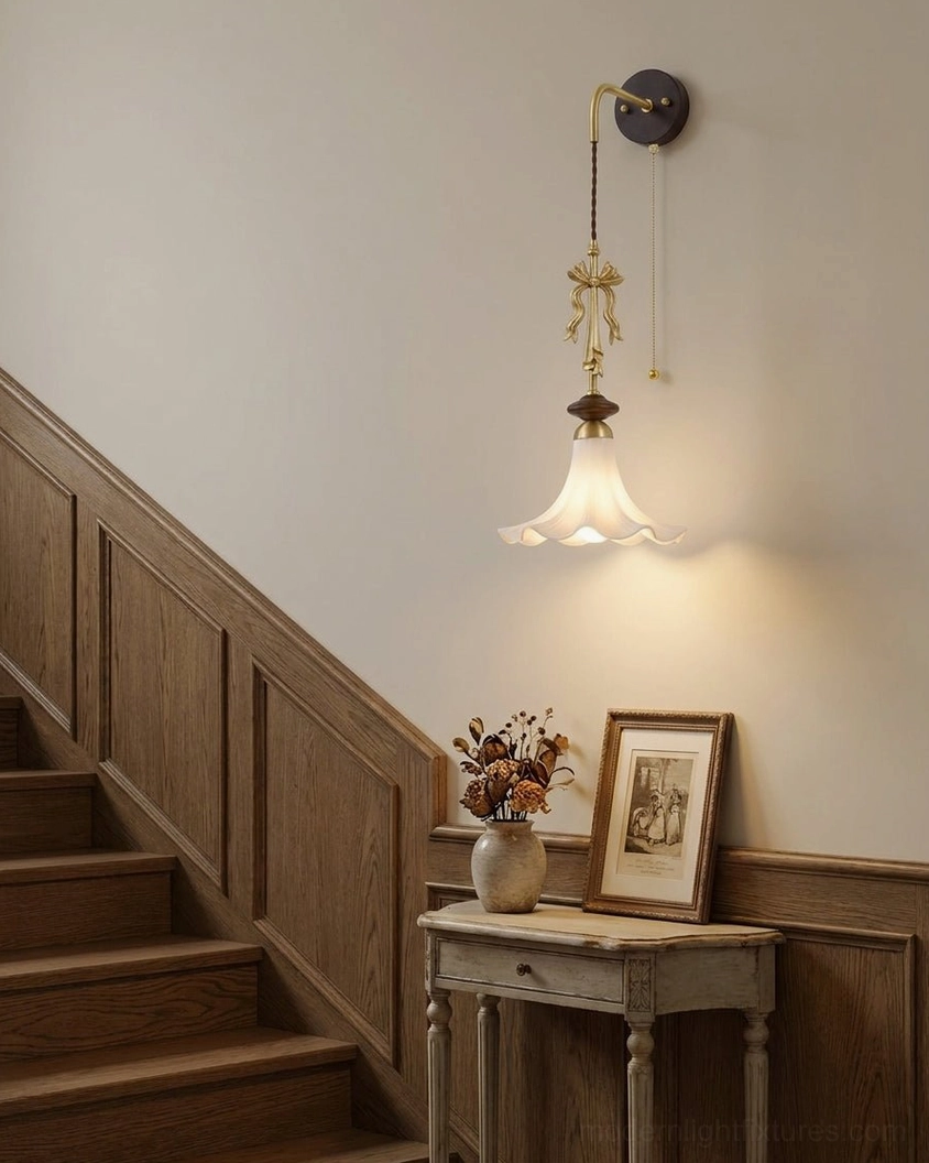 Bellora wall sconce illuminating traditional stairwell with wood paneling and warm residential style
