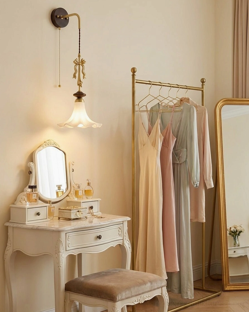 Bellora wall sconce at dressing table with white vanity, brass accents, and frosted glass shade