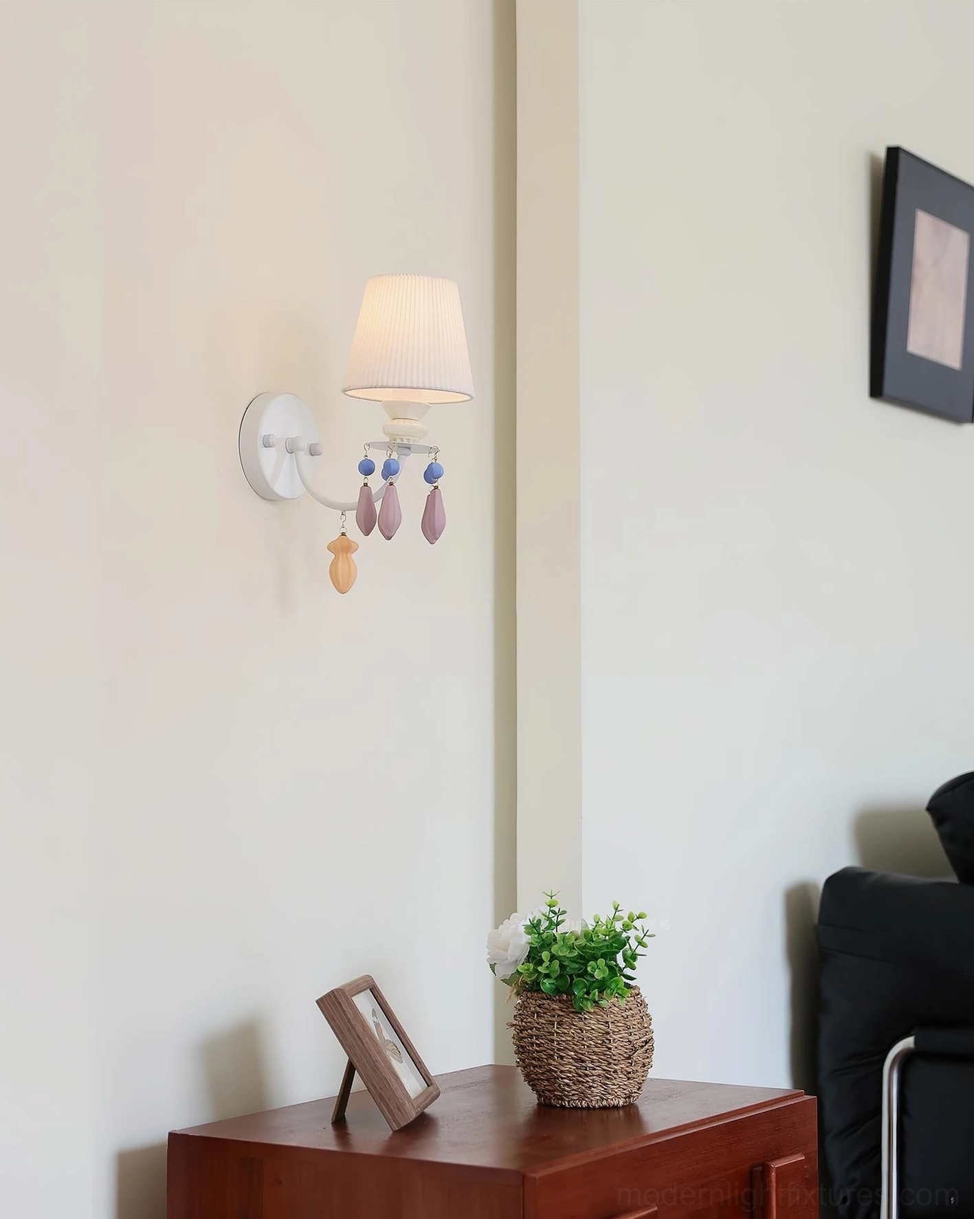 Belvianne ceramic wall sconce architectural detail shot showing pleated texture and metal frame construction close-up