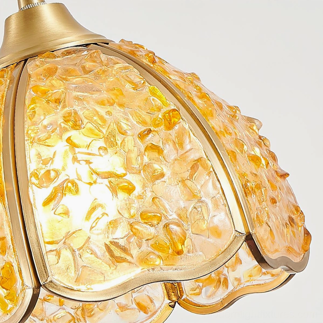 Amber and yellow-orange Beryl agate pendant lamp illuminated close-up with brass gold hardware
