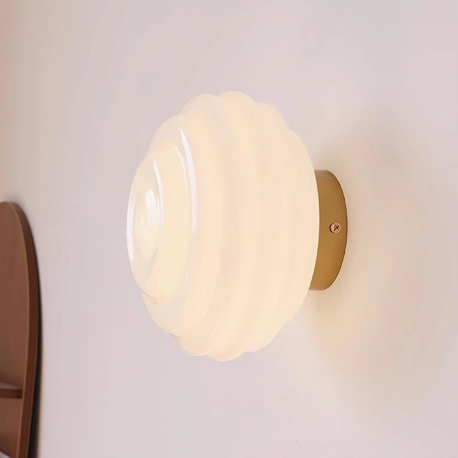 Modern Beverly wall light with gold metal base and warm ambient glow in residential interior