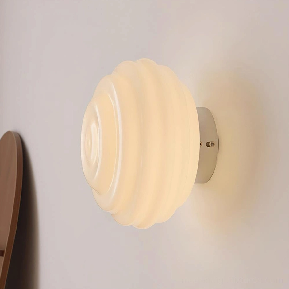 Beverly contemporary wall sconce with chrome silver finish in bedroom setting with wooden shelf