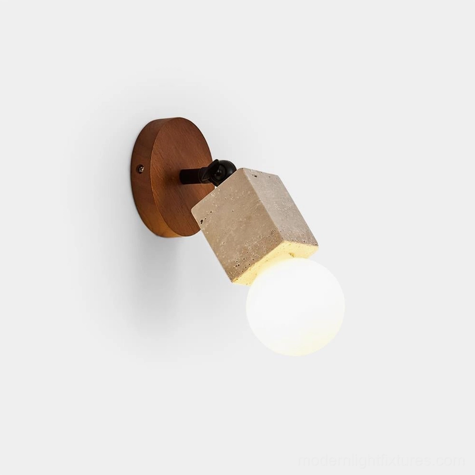 Bezel travertine wall sconce with walnut base and frosted glass orb, side profile view on white background