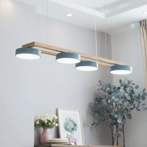 Bird pendant light fixture in contemporary dining room with blue-grey shades and wood crossbar