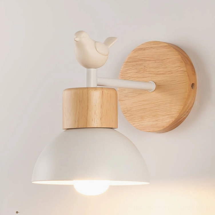 Bird wall sconce side view showing lit warm bulb, natural wood grain texture, and Scandinavian minimalist style