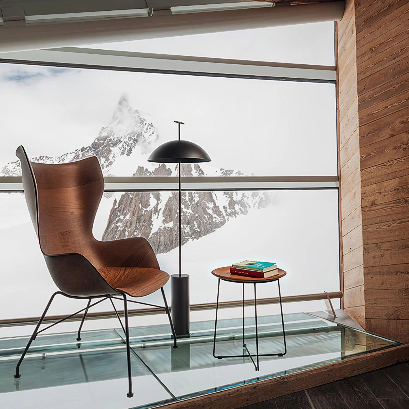 Black dome floor lamp in mountain-view modern living room with wood-paneled interior and leather accent