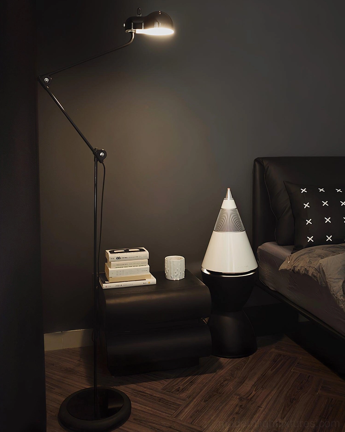Black swing arm floor lamp illuminated in modern bedroom interior paired with contemporary furniture