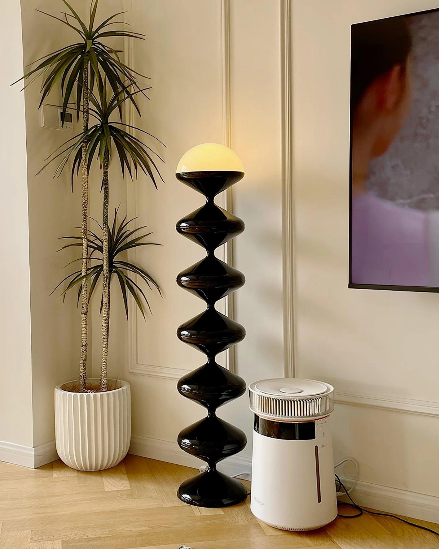 Modern black gourd floor lamp with warm LED glow in Nordic Scandinavian interior design