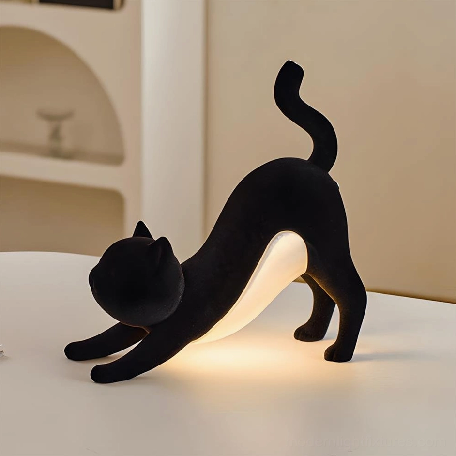 Black Hakimi cat table lamp with matte flocked finish and warm ambient glow