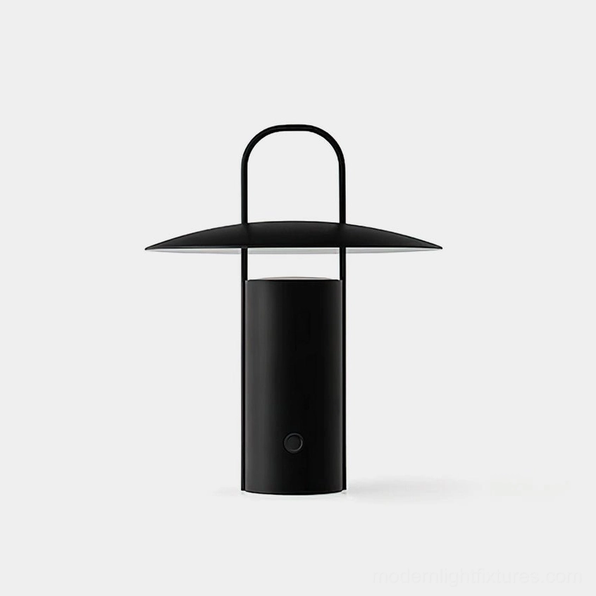 Modern minimalist matte black LED table lamp with integrated carry handle on white studio background