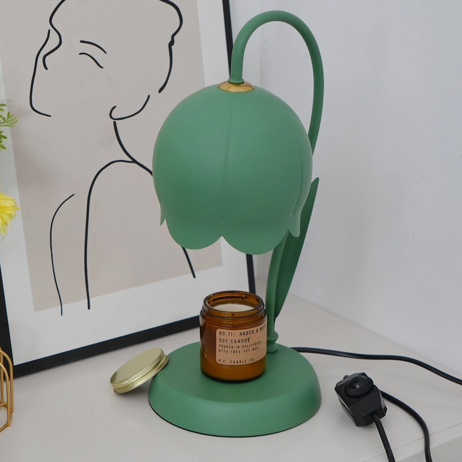 Black lily flower candle warmer table lamp showing matte metal finish and sculptural bell-shaped design