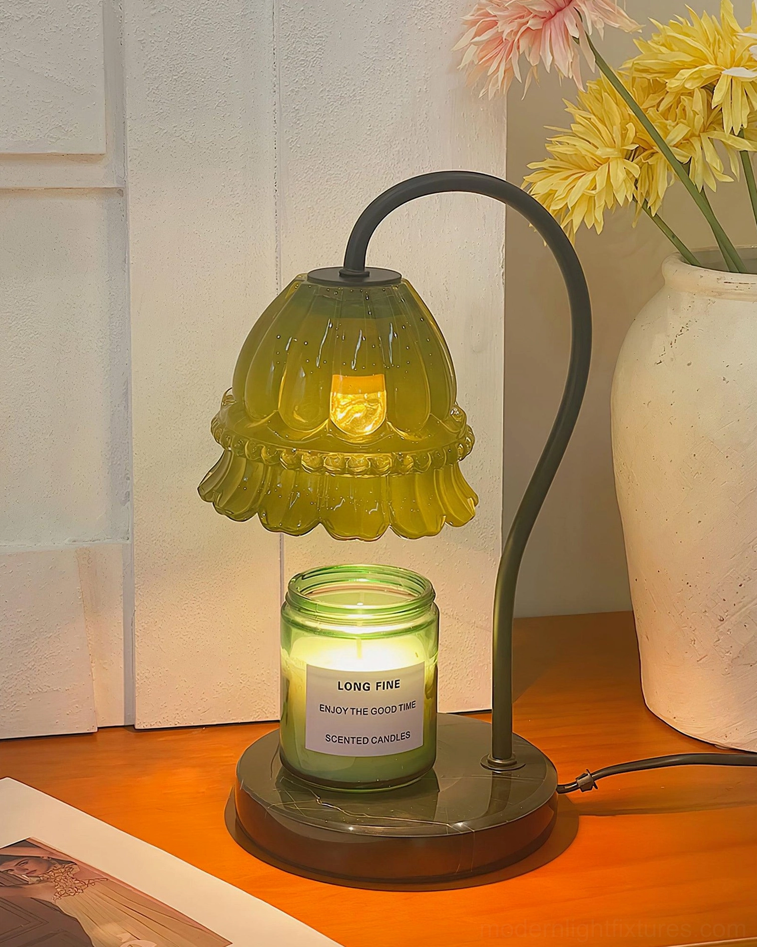 Black marble candle warmer lamp on contemporary bedside table with ambient lighting