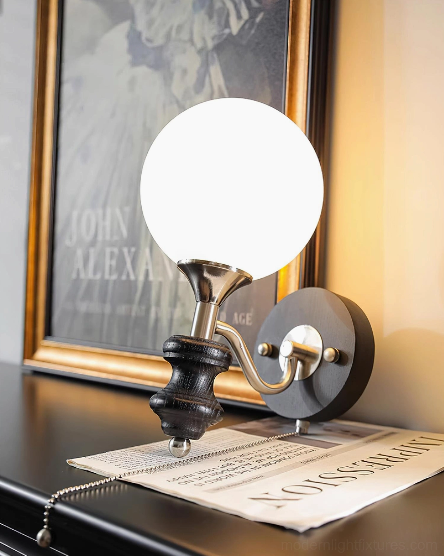 Black matte finish spherical wall sconce with frosted globe and metal armature