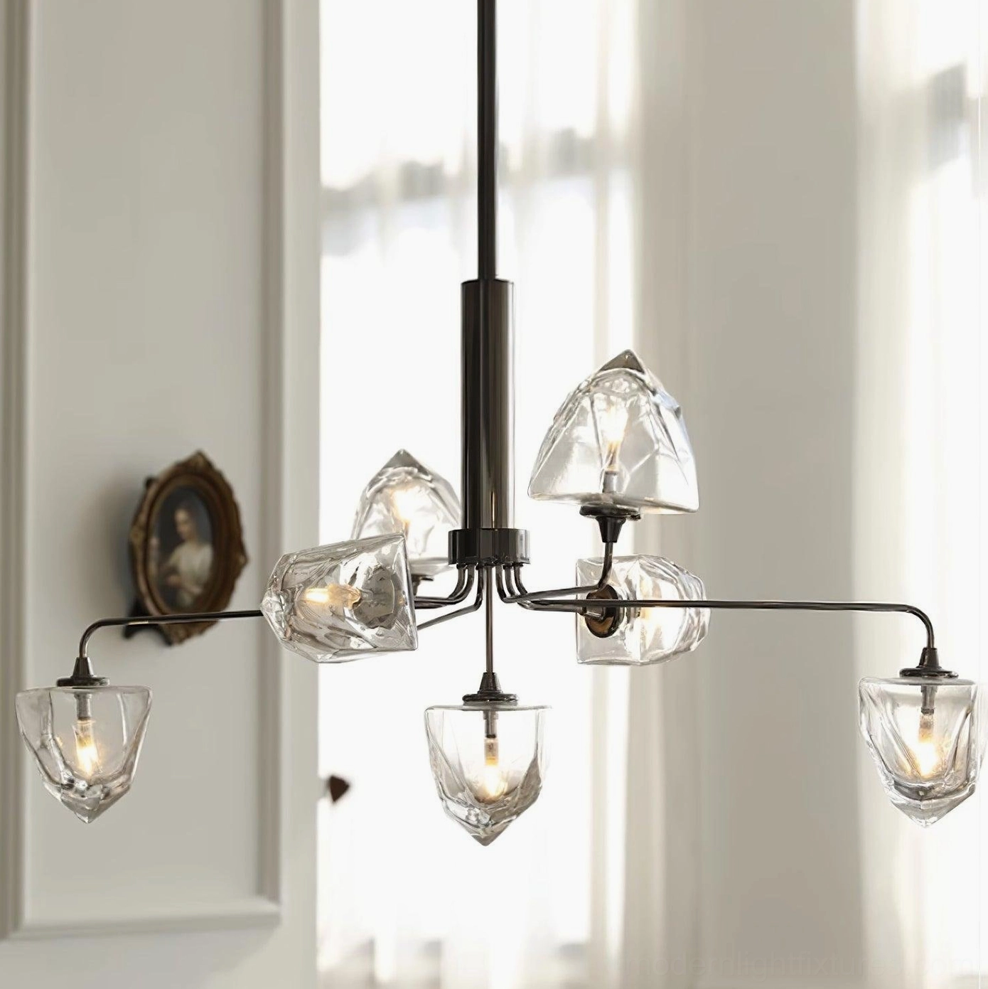 Black metal frame modern chandelier with clear glass shades displayed in contemporary living room by window