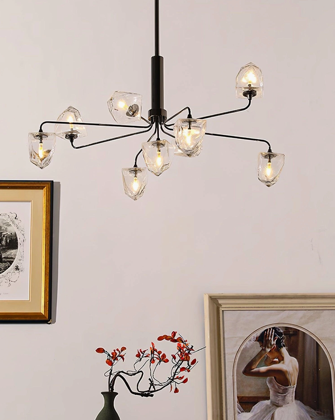 Black metal modern chandelier with clear faceted glass shades mounted in contemporary home space