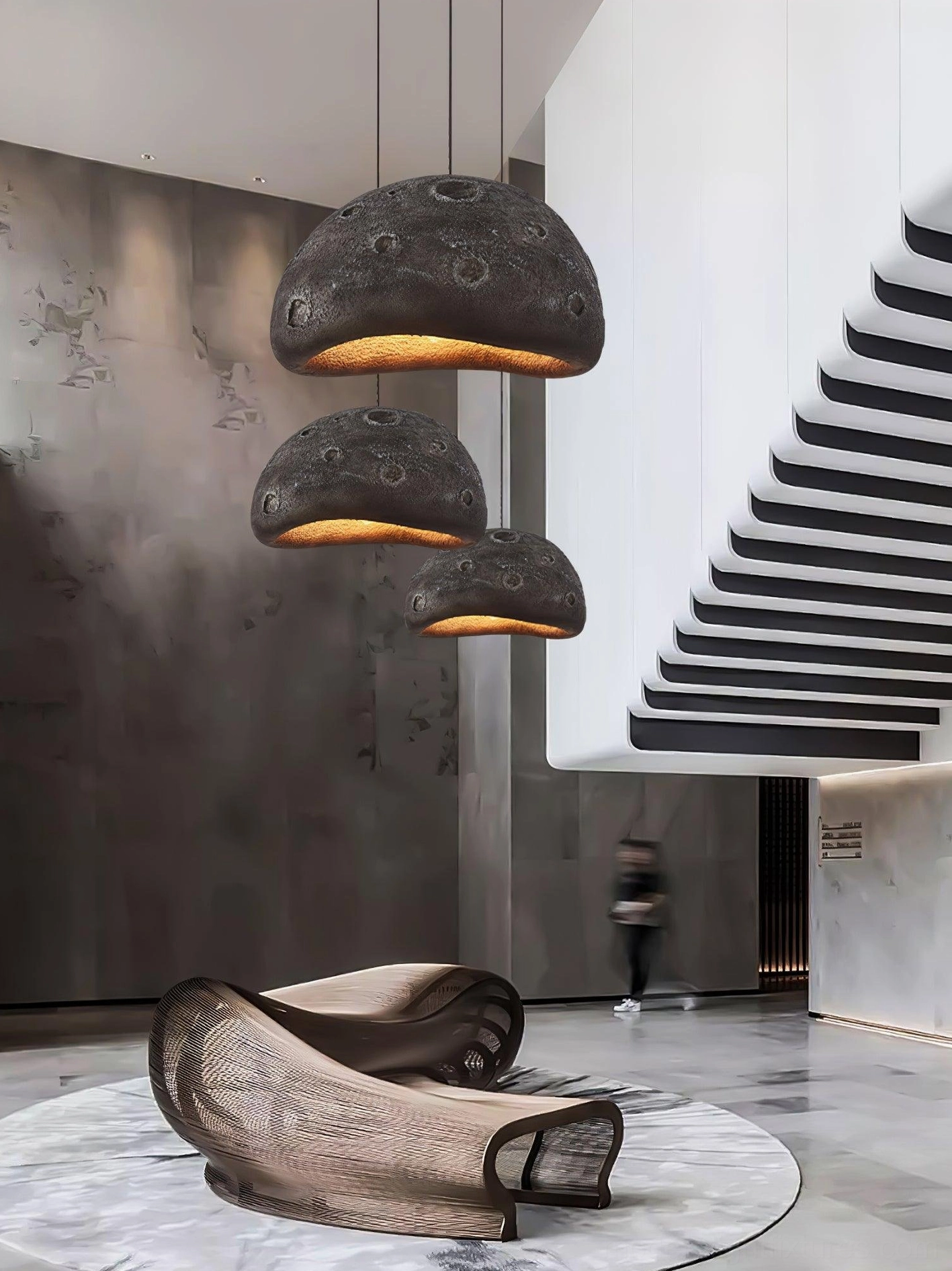 Black meteorite crater pendant light in commercial hospitality space creating ambient focal lighting