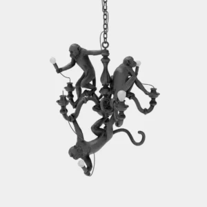 Black monkey chandelier with three resin primates and candle-style bulb sockets displayed in front oblique studio view
