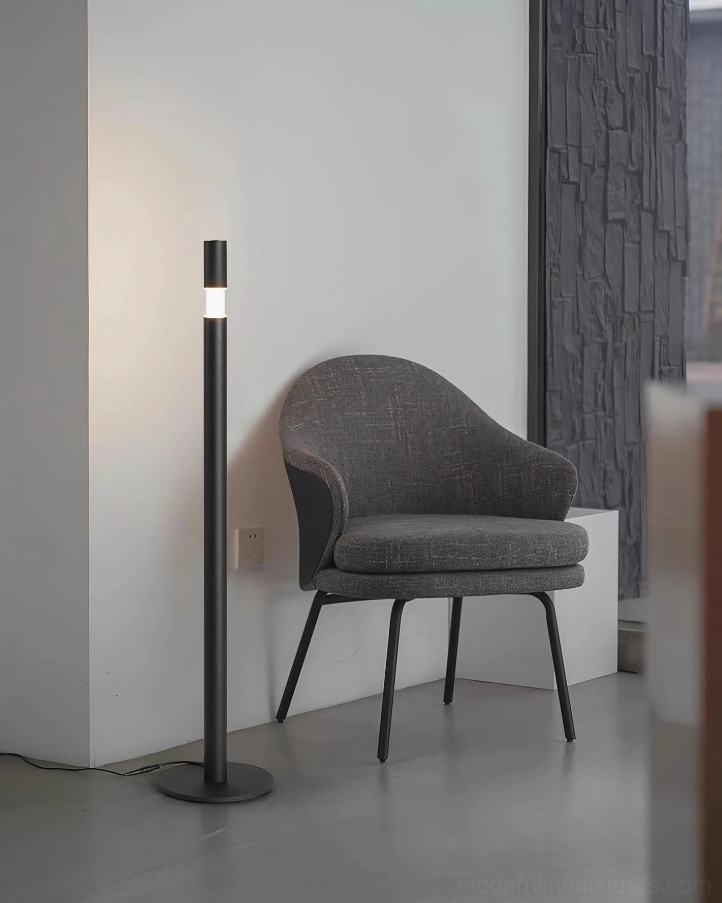 Black Obelisk floor lamp with dual accent lighting heads in modern living room with grey chair