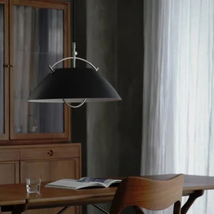 Contemporary black pendant light with silver hardware in modern dining room setting