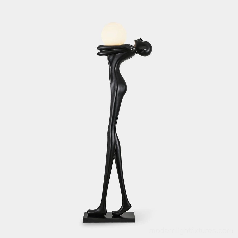 Black matte resin sculpture floor lamp with frosted glass globe, left front three-quarter studio view, modern art lighting design