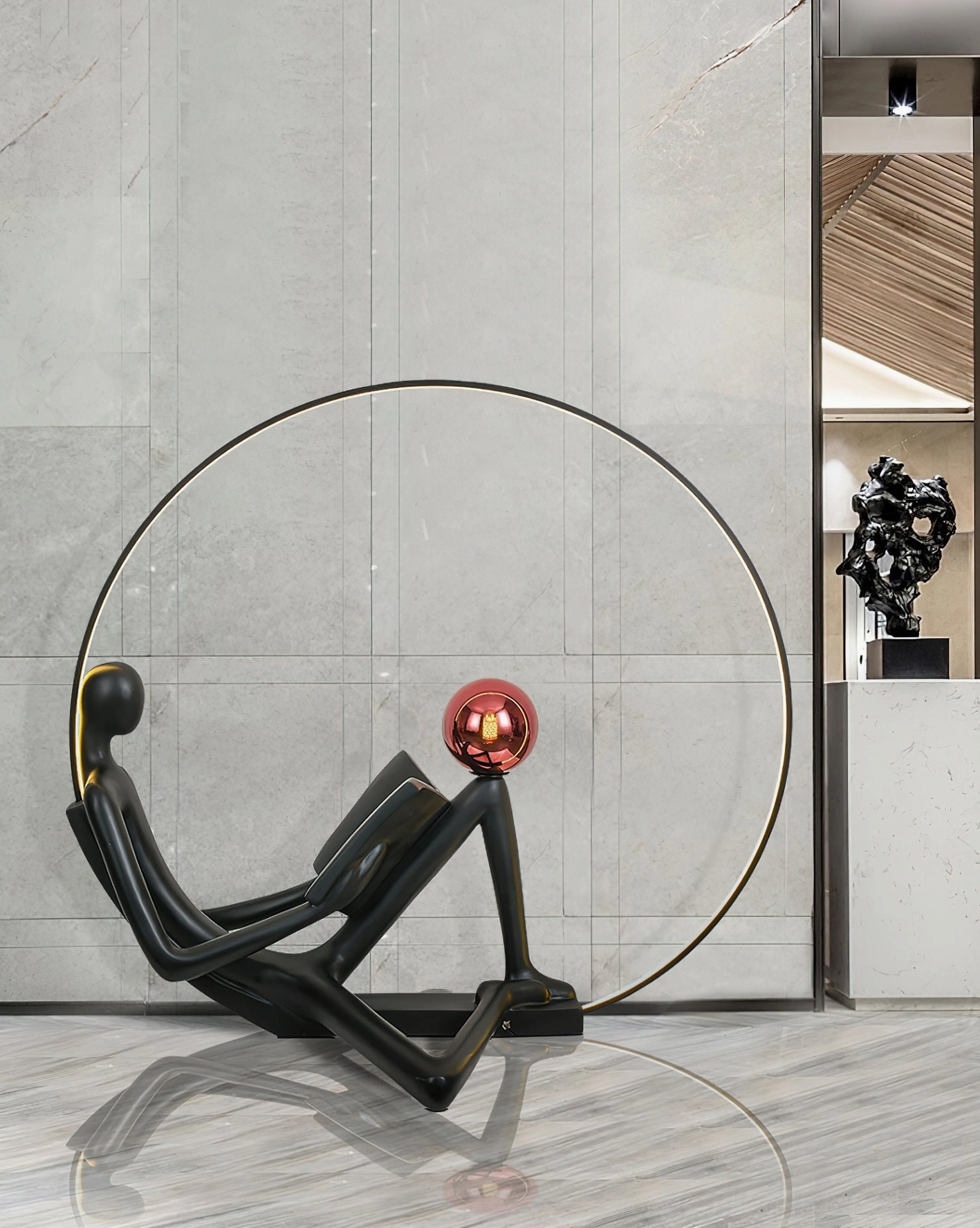 Minimalist black reader statue floor lamp with red accent, modern lobby entryway with polished marble floor