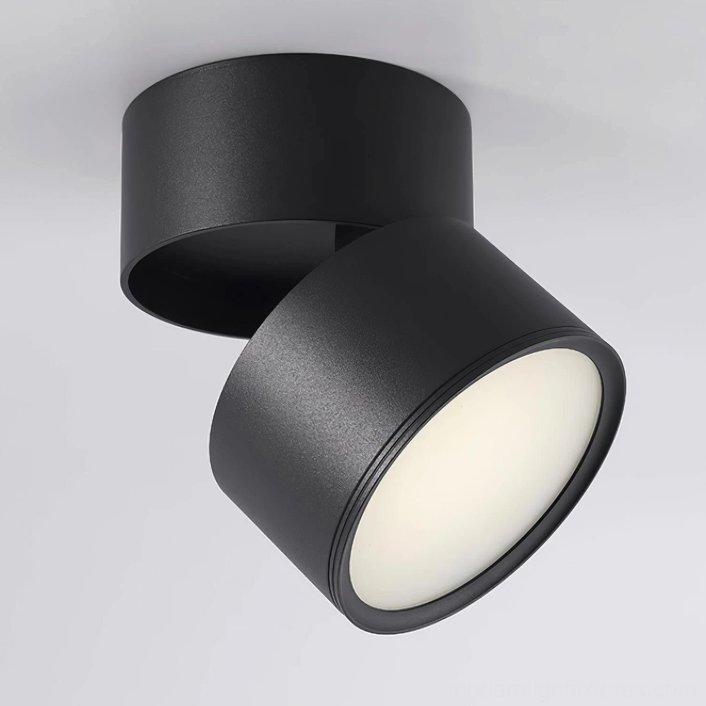 Matte black adjustable surface spotlight front view - compact rotatable ceiling light fixture for contemporary interiors