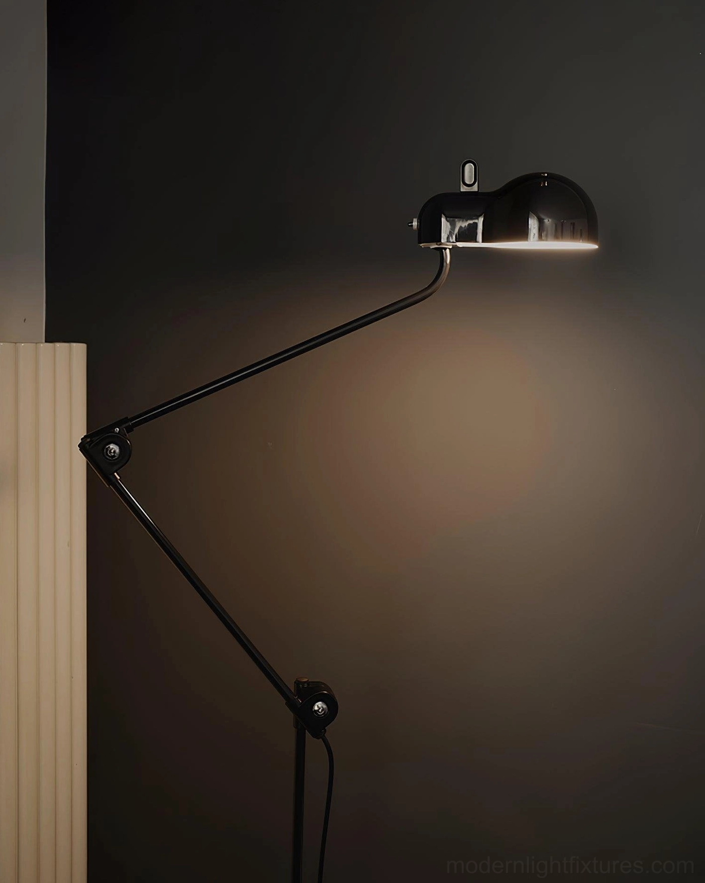 Black matte articulated swing arm floor lamp with minimalist dark background showcasing industrial design aesthetic