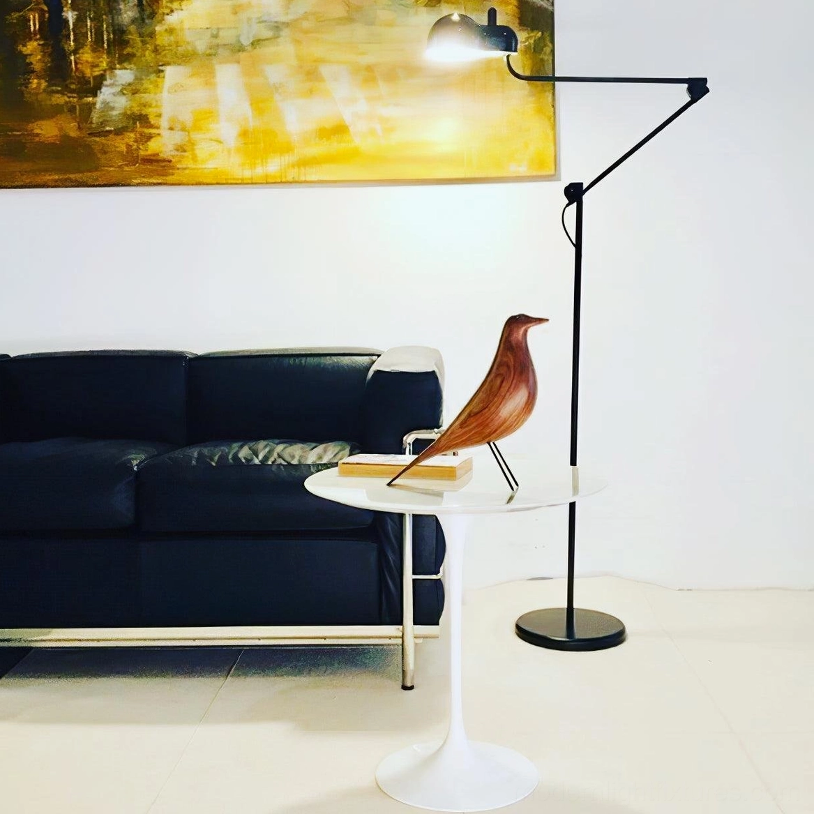 Black matte swing arm floor lamp with adjustable arm in modern living room interior design context