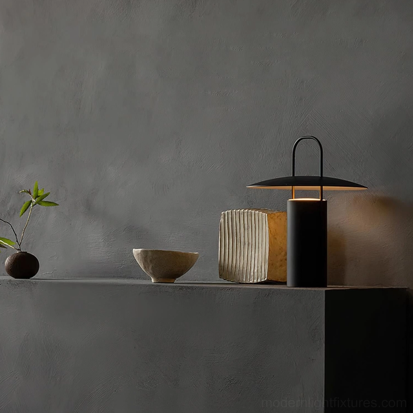 Matte black minimalist LED table lamp with warm illumination on console table with ceramic decor
