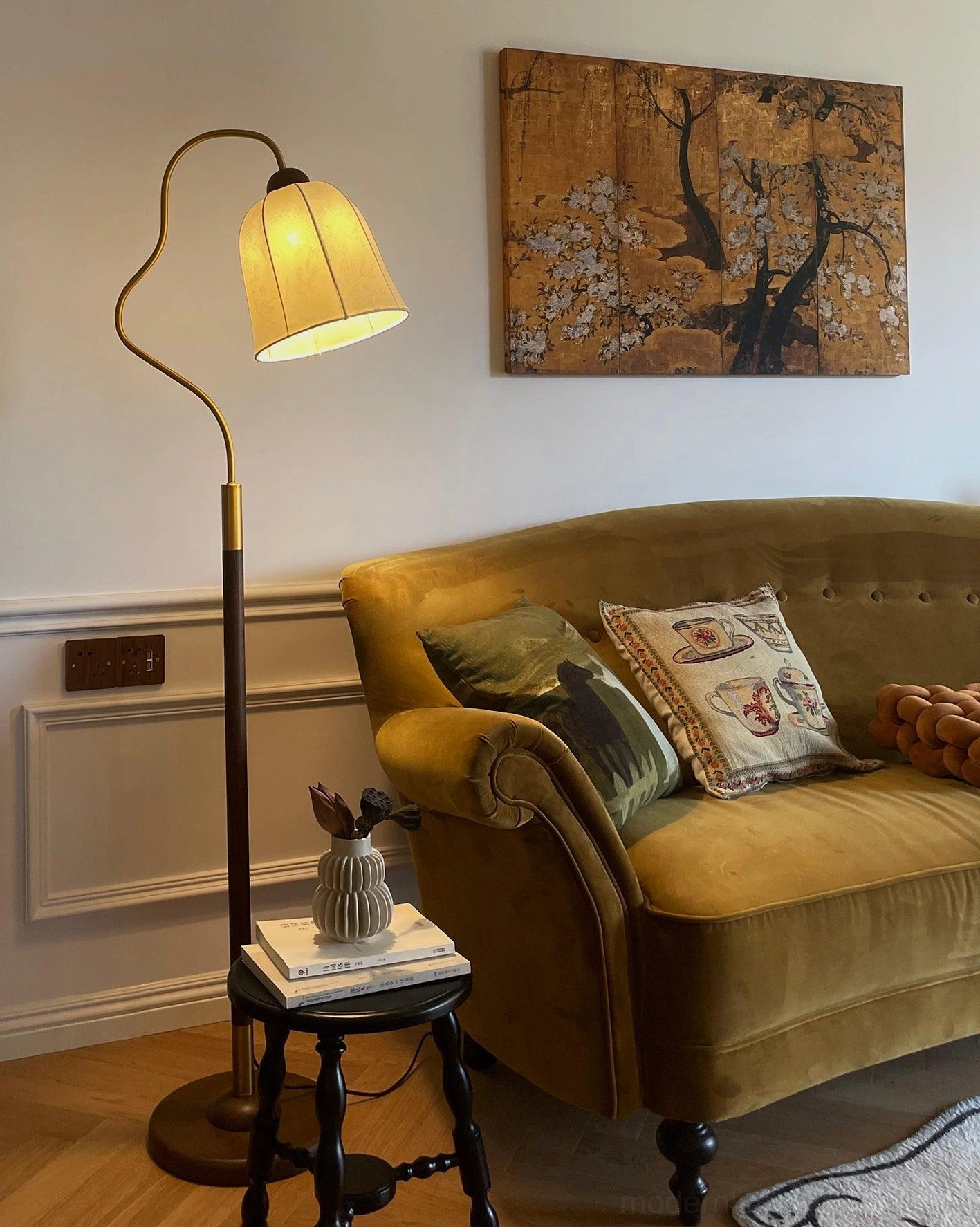 Black walnut arc floor lamp in contemporary interior with modern furnishings and neutral palette