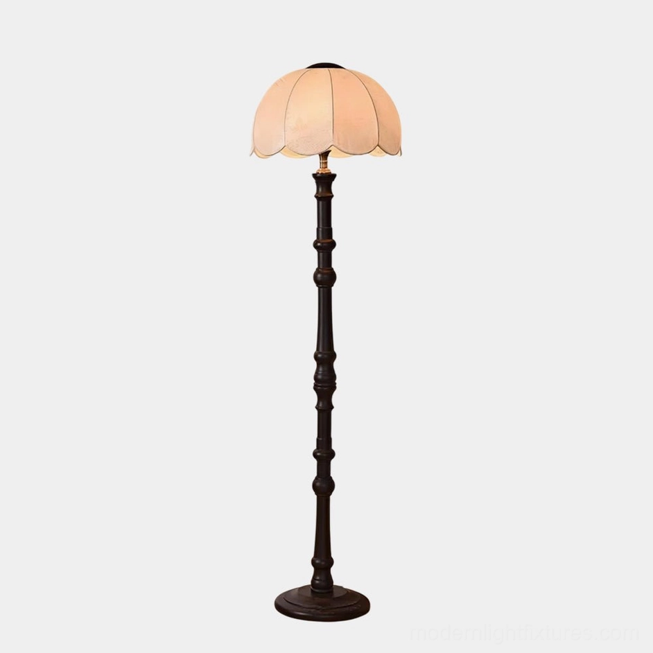Black and white scalloped vintage floor lamp with carved wooden stand in contemporary interior setting