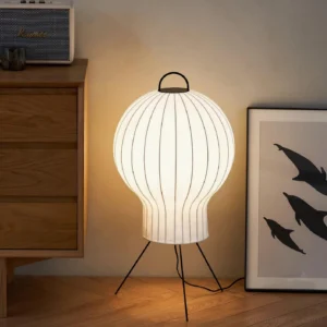 Black and white silk lantern floor lamp with vertical ribbed texture and metal tripod base